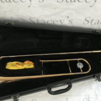 A cased Yamaha trombone.