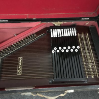 Three cased autoharps.