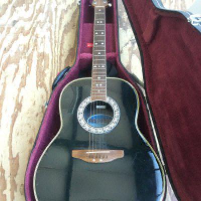 An Ovation Celebrity bowl back acoustic guitar with hard carry case.