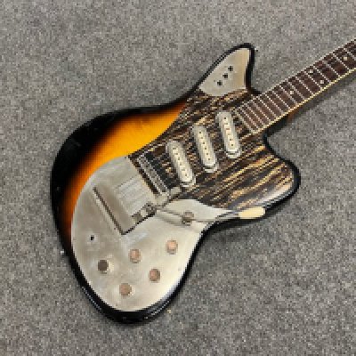 A 1964 Framus Strato De Luxe Electric Guitar. 3 pickup with all original parts. Condition good overall with some edge marking and playwear to the body. US 1 cent coins glued to the tops of each control. Comes with non original gig bag.