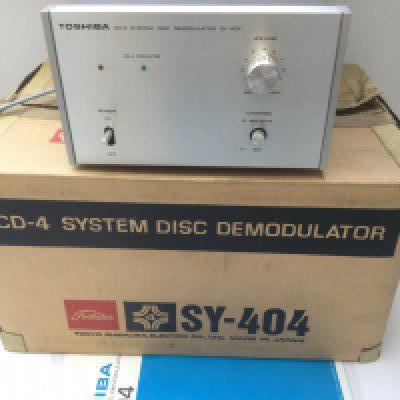 A boxed Toshiba SY-404 CD-4 system disc demodulator with manual.