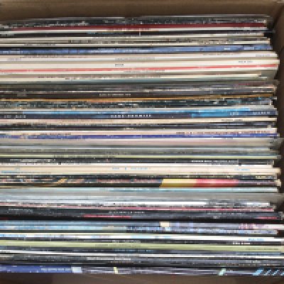 A box of LPs by various artists including Deep Purple, Rainbow, The Rolling Stones and others.
