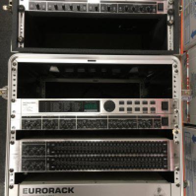 Three rack effects units and a Eurorack 150w power supply housed in hard shell cases.