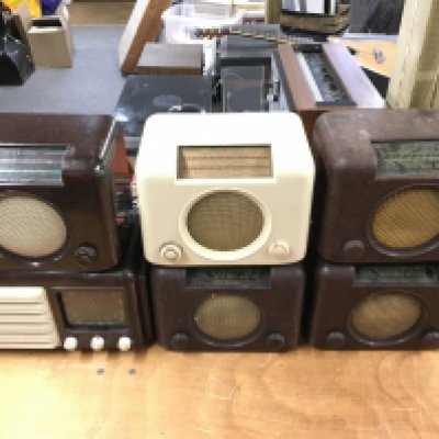 Six Bakelite radios.