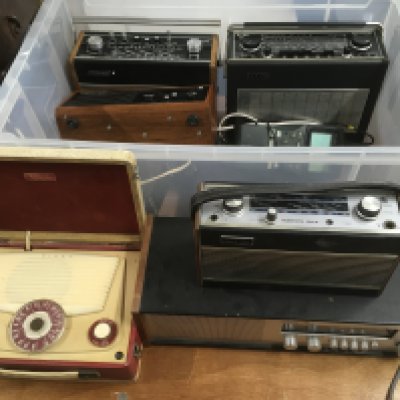 A collection of vintage radios, spare valves, circuit boards and other accessories.