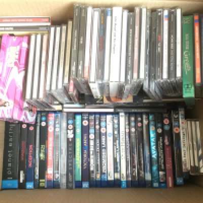 Four boxes of BluRays, DVDs and CDs.