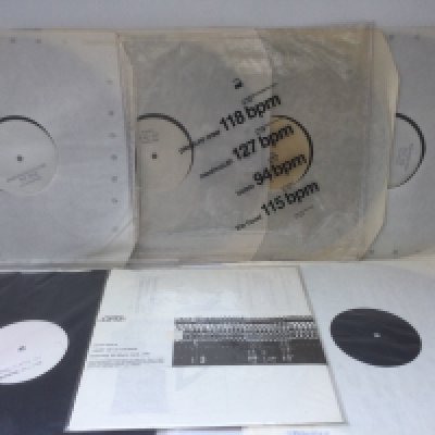 A small collection of white label records including a Factory Records four disc set.