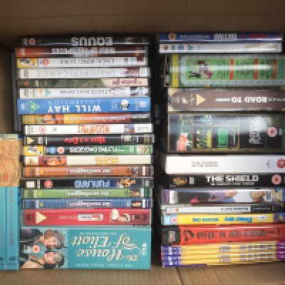 Four boxes of DVDs and BluRays including various box sets.