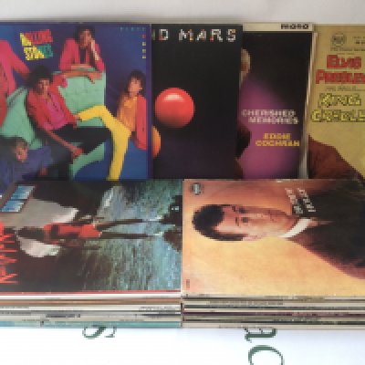 A box and bag of LPs, EPs and 7" singles by various artists including Elvis Presley, Eddie Cochran, The Beatles and many more.