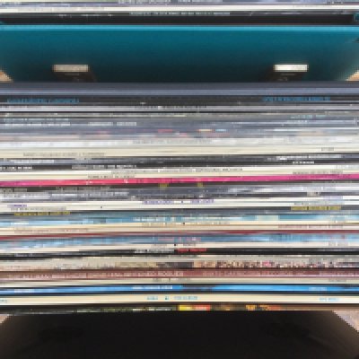 Three record cases of LP by various artists including Steely Dan, Thin Lizzy, Genesis and others.