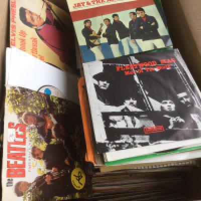 Two boxes containing 7" singles and EPs by various artists including Jimi Hendrix, David Bowie, The Beatles and many more.