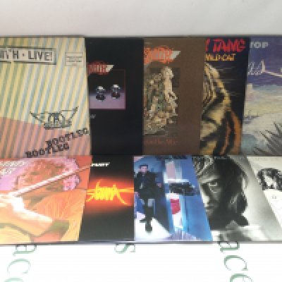 Two bags containing twenty rock LPs by various artists including Aerosmith, Blue Oyster Cult, Bad Company and others. Includes three promo discs.