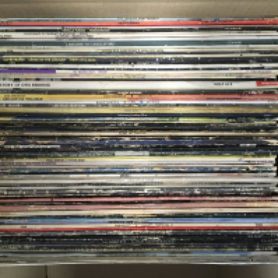 A box of LPs and cassettes by various artists including The Clash, AC/DC, The Byrds and many more.