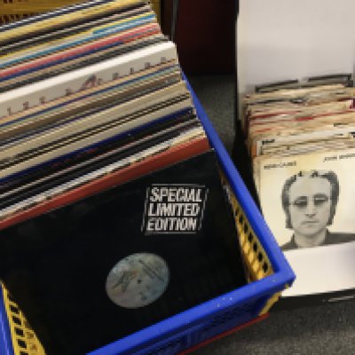 A box of LPs, 12" and 7" singles by various artists including Alice Cooper, Television, The Who and others. Also includes some 7" single paper sleeves.