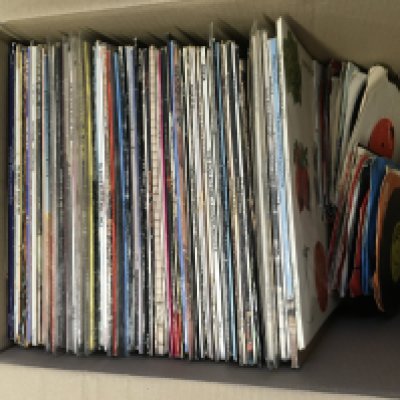 A box of LPs, 12" and 7" singles by various artists including Cream, Steely Dan, Manfred Mann's Earth Band and others.