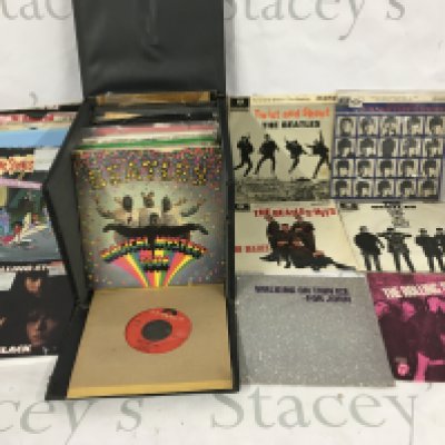 A record case of Beatles, Rolling Stones and related 7" singles and EPs.