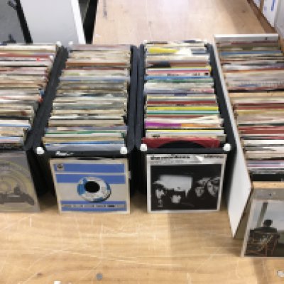 Five boxes and six record cases of 7" singles by various artists from the 1960s onwards.