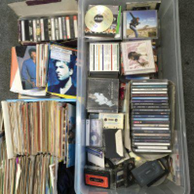 A collection of 7" paper sleeves, CDs and cassettes.