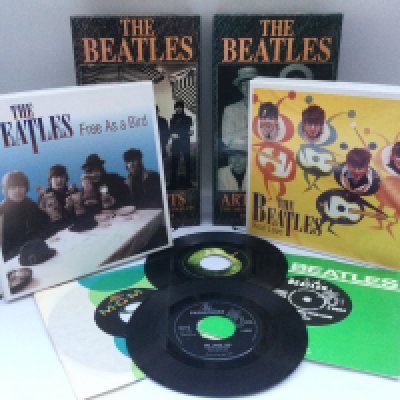 Four Beatles box sets and 7" singles. Please note that Free As A Bird and Real Love are lacking their CDs but do include their records.