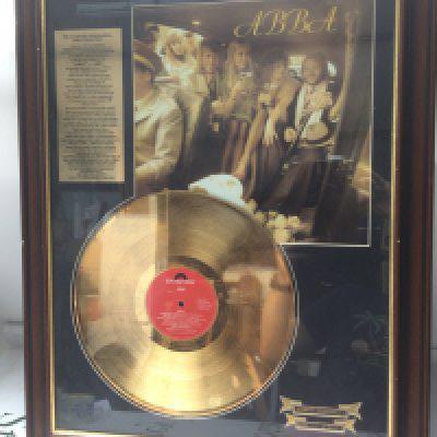 A framed and glazed limited edition gold disc of the self titled Abba LP, numbered 119/5000, with COA to reverse.