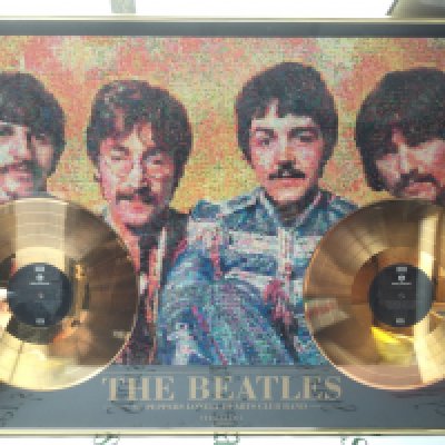 A framed and glazed limited edition double gold disc and photomosaic display for The Beatles' Sergeant Pepper's Lonely Hearts Club Band album. Numbered 003/500. Comes with a framed and glazed Moody Blues CD display with facsimiling signatures (2).