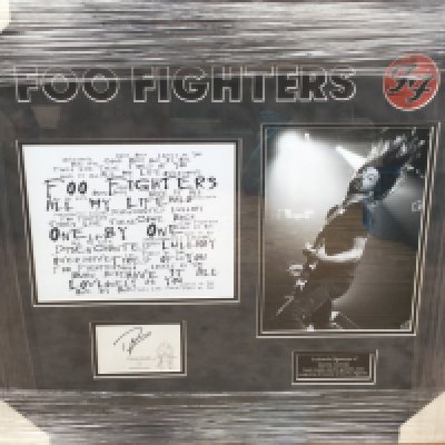 A framed and glazed Foo Fighters display signed by Dave Grohl with COA, approx 58.5cm x 66cm.