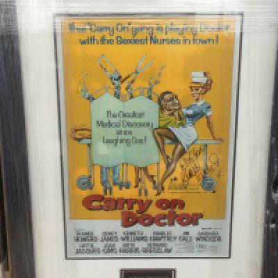 A framed and glazed Carry On Doctor mini poster signed by Barbara Windsor with COA, approx 63cm x 47cm.