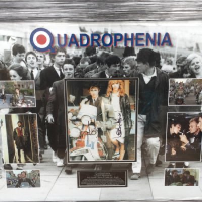 A framed and glazed display of Quadrophenia signed by Phil Daniels and Leslie Ash with COA, approx 66cm x 79cm.