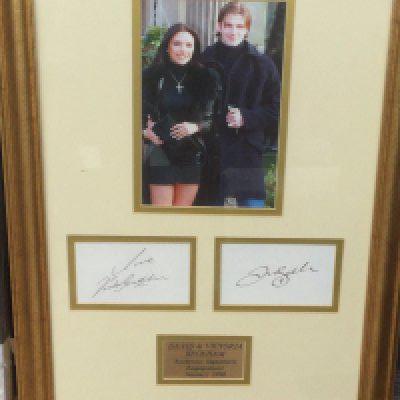 A framed and glazed signed display of David and Victoria Beckham, approx 61cm x 43cm.