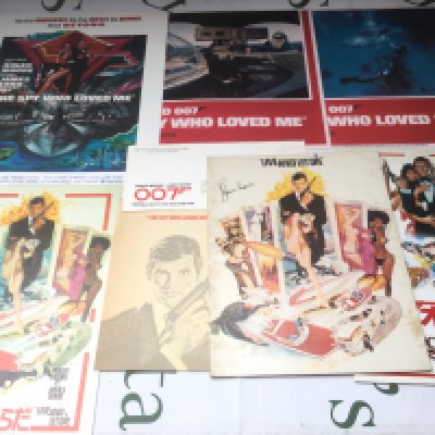 A collection of Roger Moore era James Bond lobby cards and film programs.