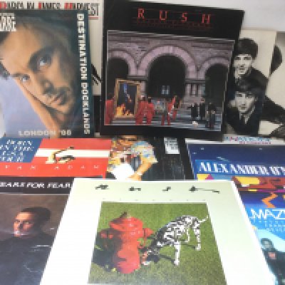 A collection of rock and pop music programs including some with tickets. Artists include Bruce Springsteen, Rush, Bryan Adams and others.