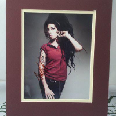 A signed photo of Amy Winehouse with COA.