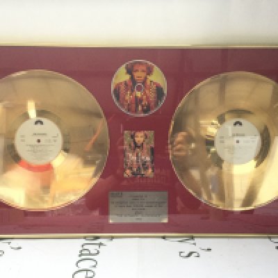 A framed and glazed double gold disc display for the Jimi Hendrix LP The Ultimate experience, approx 80cm x 40cm.