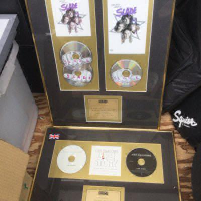 Four framed and glazed CD displays for various artists including Slade, The Shadows, Lionel Richie and David Cassidy.