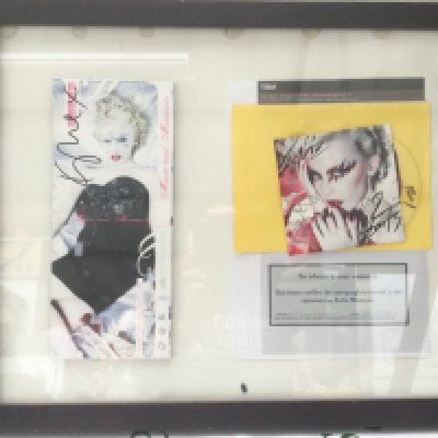 A framed and glazed signed montage of Kylie Minogue with COA, approx 55cm x 45cm.