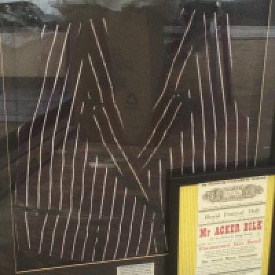 A framed and glazed stage worn waistcoat signed by Acker Bilk in 1964 together with a signed Acker Bilk program from 1962 (2).