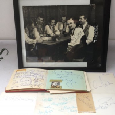 An autograph booklet containing various signatures including Monty Sunshine, Ken Collyer, Chris Barber and others plus a signed photo of Acker Bilk and his band.