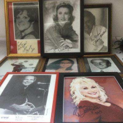 A collection of signed and framed photos of musicians and singers including Dolly Parton, Bobby Vee, Brenda Lee and others.