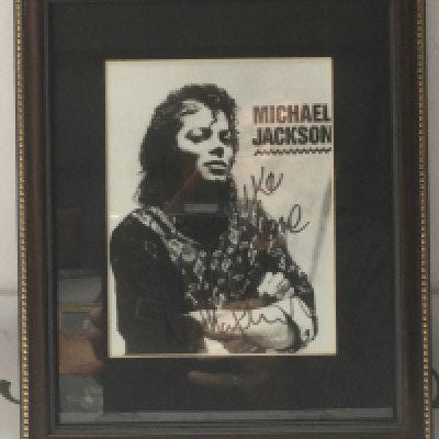 A framed and glazed signed photo of Michael Jackson. No COA.