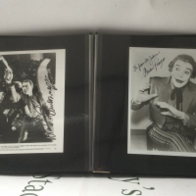 A binder of signed photos comprising Cesar Romero, Jimmy Stewart, Roy Rogers, Kirk Douglas and others.