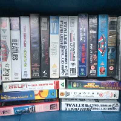 Two boxes of Beatles related DVDs, VHS tapes, fan club magazines etc.