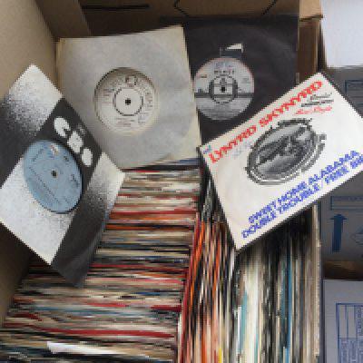 Two boxes of promo 7" singles by various artists including Wings, Billy Joel, The Beach Boys and many more plus some foreign Beatles singles and Elvis Presley EPs.
