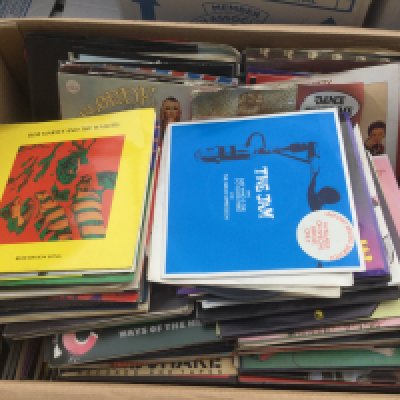 Two boxes of 7" singles by various artists including The Jam, Bob Marley, Bruce Springsteen and many more.