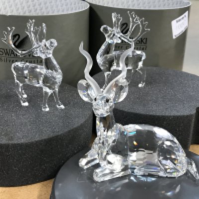 A Swarovski "Inspiration Africa-The Kudu" figure together with two Reindeer figures and Santa Sleigh