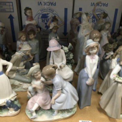 A collection of Nao figures including girl with dove on knee, large lady holding her hat and a girl with her puppy and hula hoop