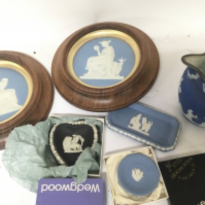 Two late 19th century Wedgwood Jasperware Neo classical wall plaques framed a Wedgwood jug and small boxed and other Wedgwood dishes.