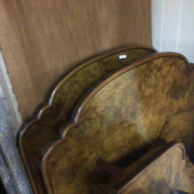 A pair of good quality early 20th century walnut single beds with side irons and drop in bed bases.