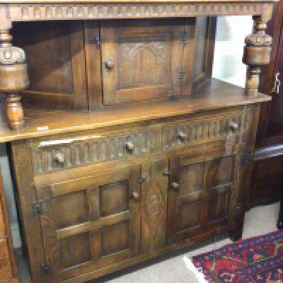 An oak 18th century style court cupboard with bulbous supports drawers and cupboards. 130x48cm. NO RESERVE