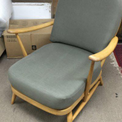 An Ercol Blonde wooden armchair, model 203. 84cm tall.