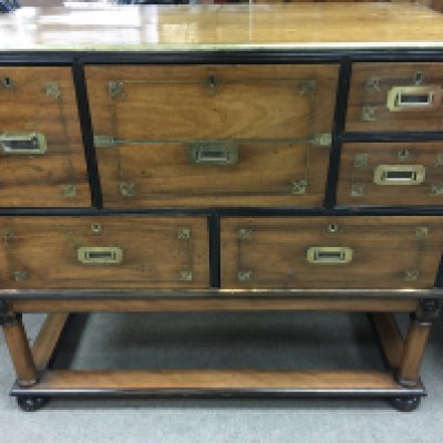 A mahogany brass bound campaign secretaire with five drawers and desk compartment on Stand . 100 cm x 50 cm Height 92 cm .